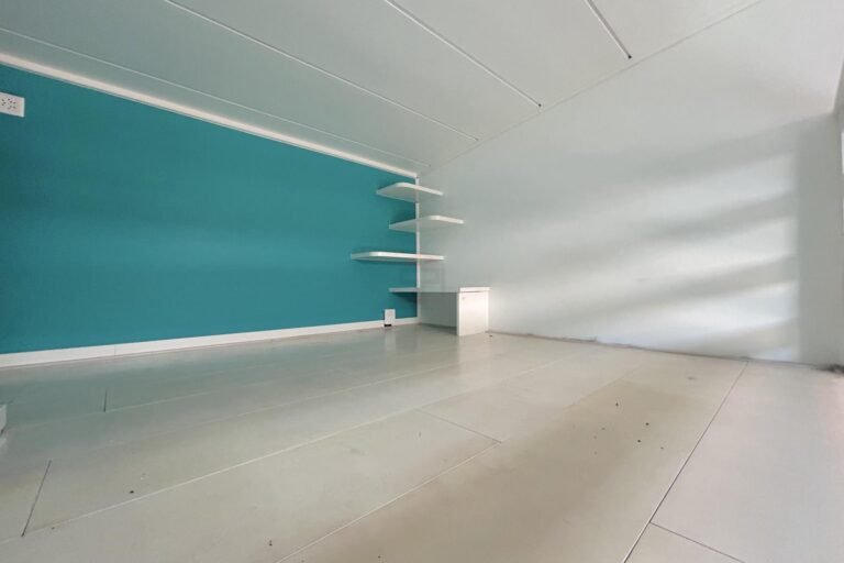 Leerer heller Raum mit türkisfarbener Wand